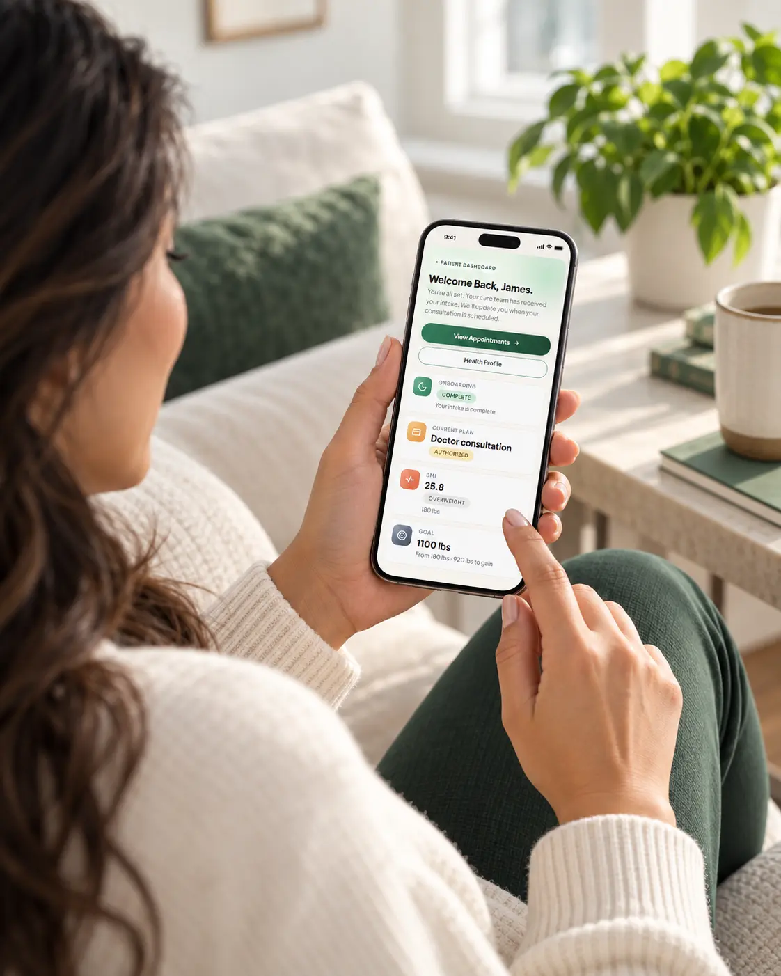 Hands completing an online medical evaluation on a phone, with a Wegovy carton nearby